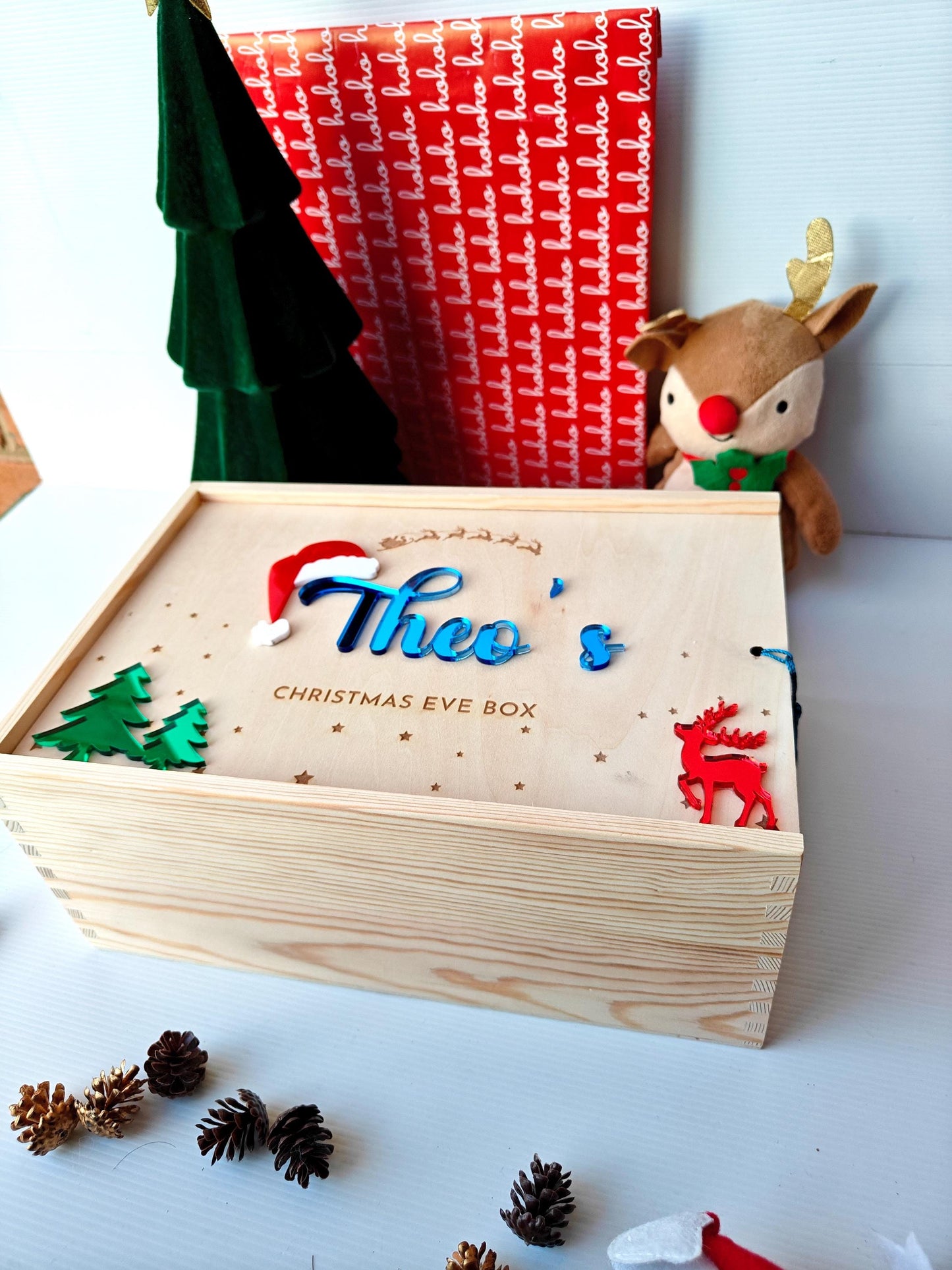 Wooden Christmas Eve box with decorative elements on a white surface
