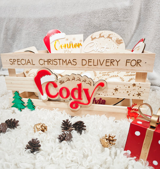 A wooden Christmas crate with cutout handles, personalised with the name 'Cody' in a bold, engraved font on the front.