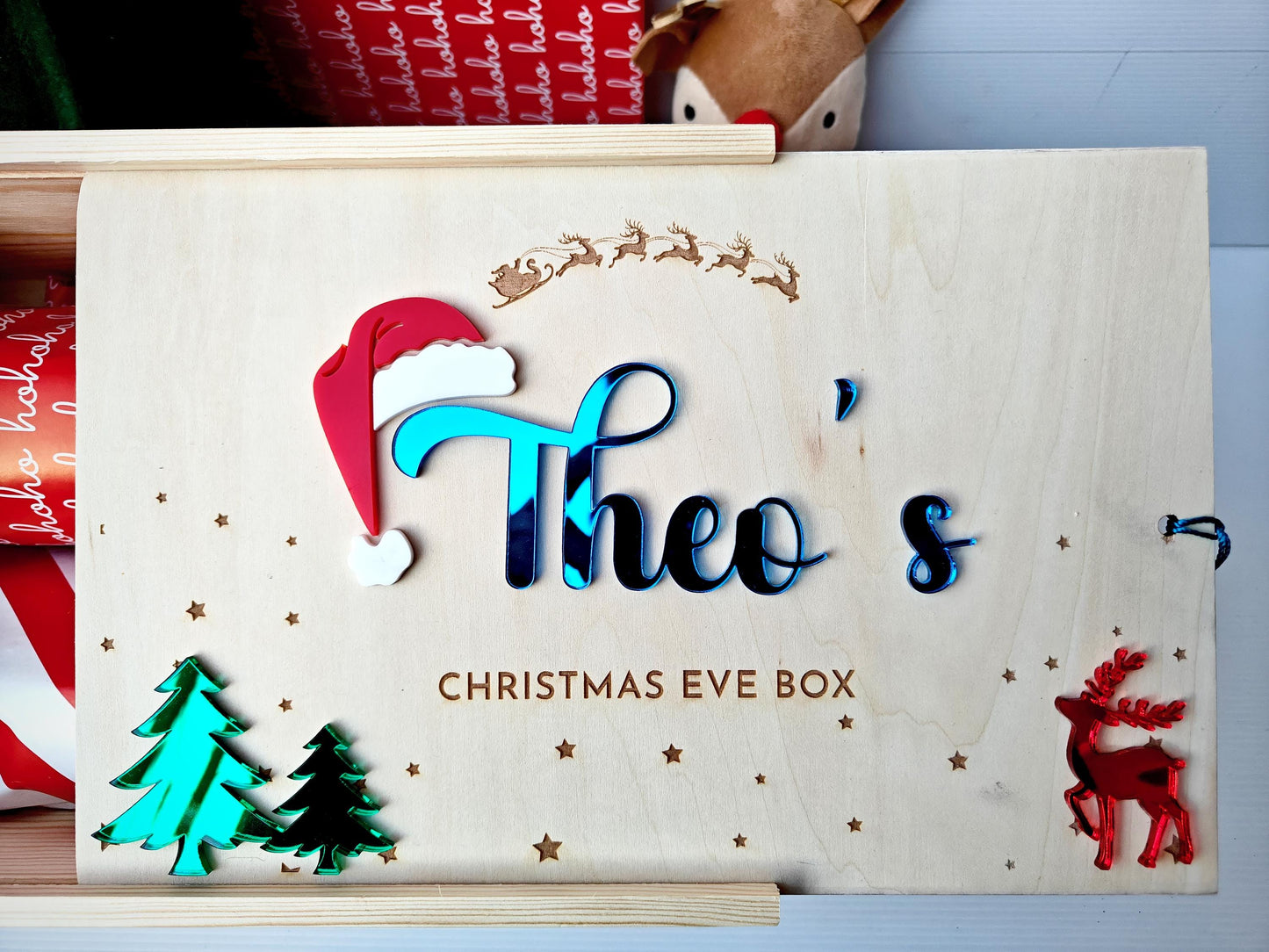 Personalized Christmas Eve box with decorative elements on a light blue background