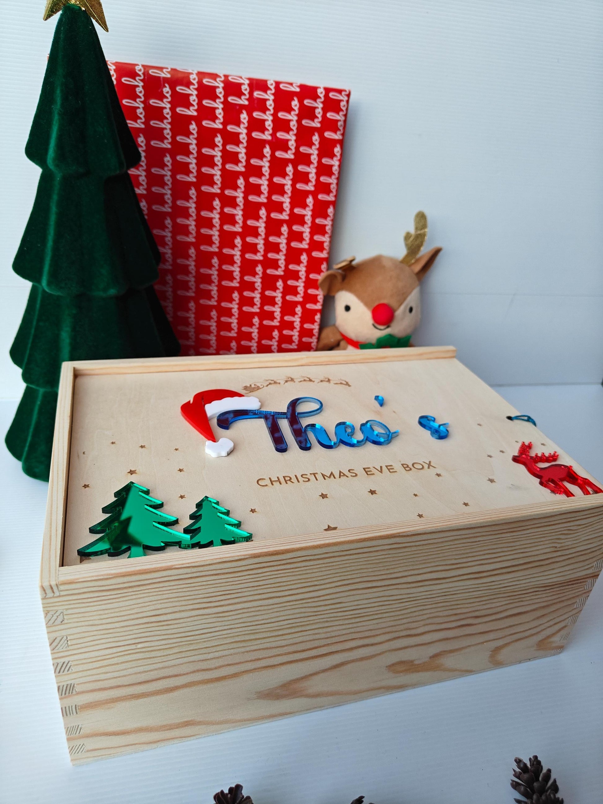 Wooden Christmas Eve box with decorative elements on a light background