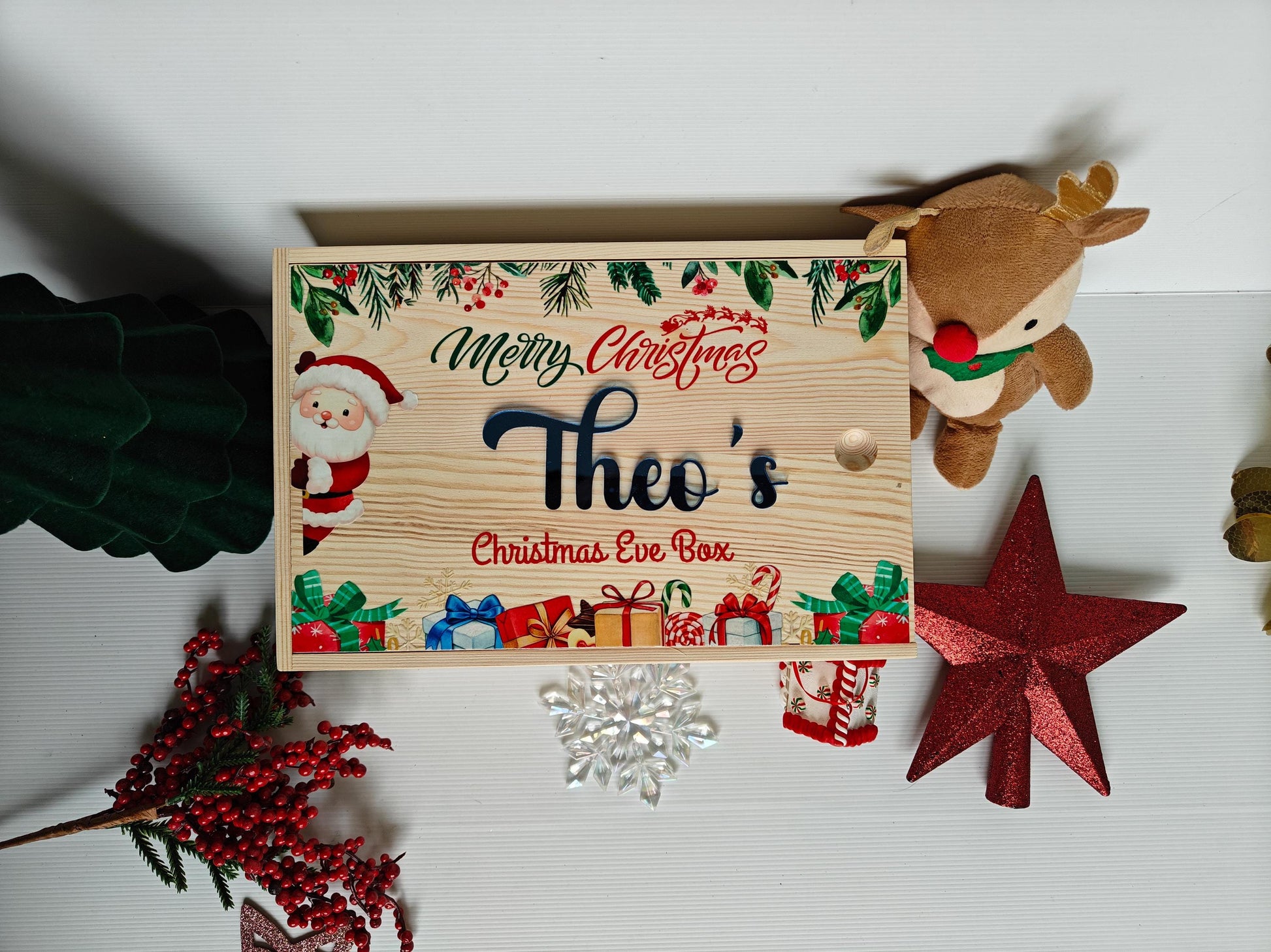 Wooden Christmas Eve box with decorative elements on a white background