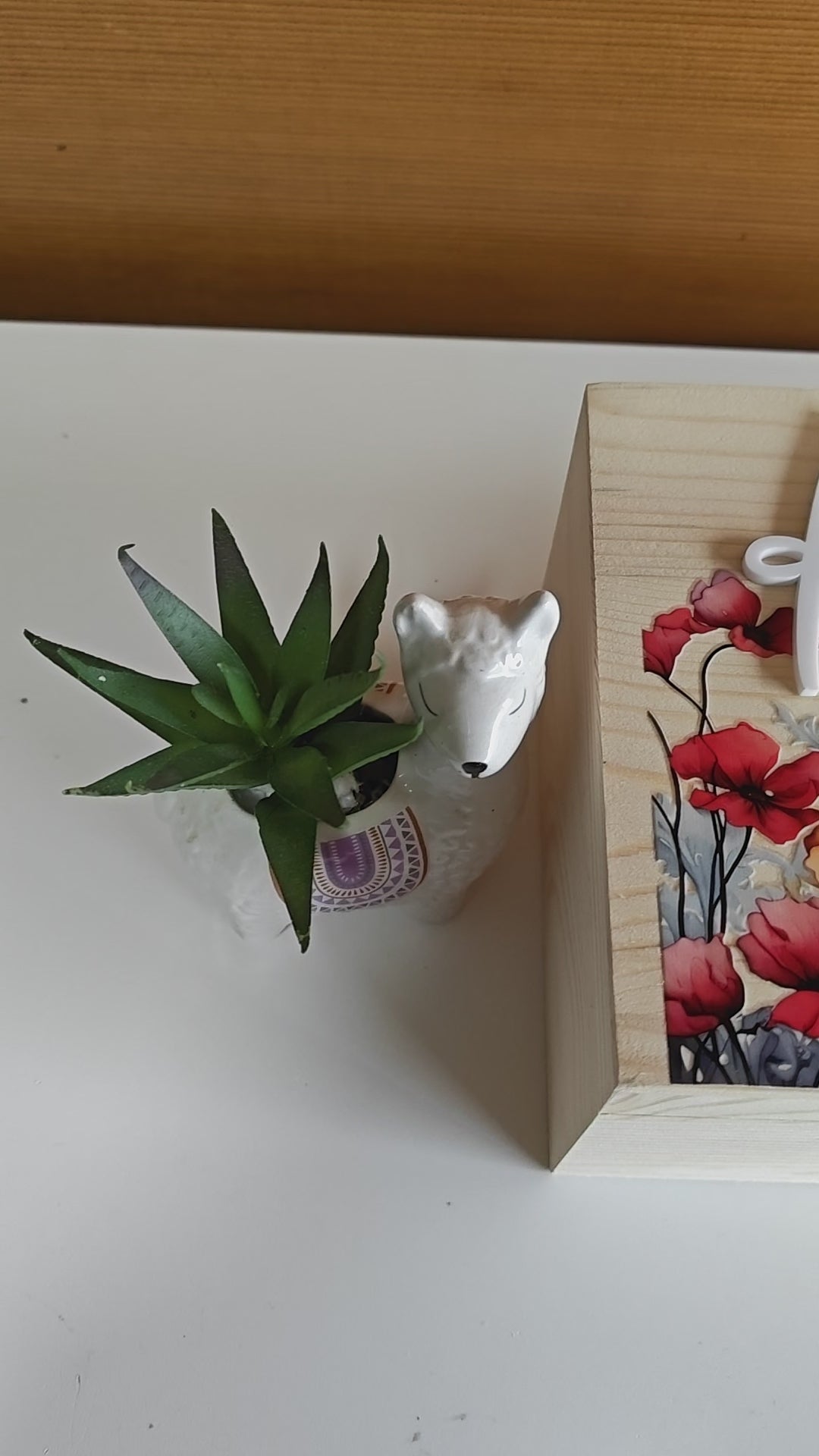 Wooden memorial box with the name 'Elizabeth Anne' engraved on the lid, shown with photos inside.
